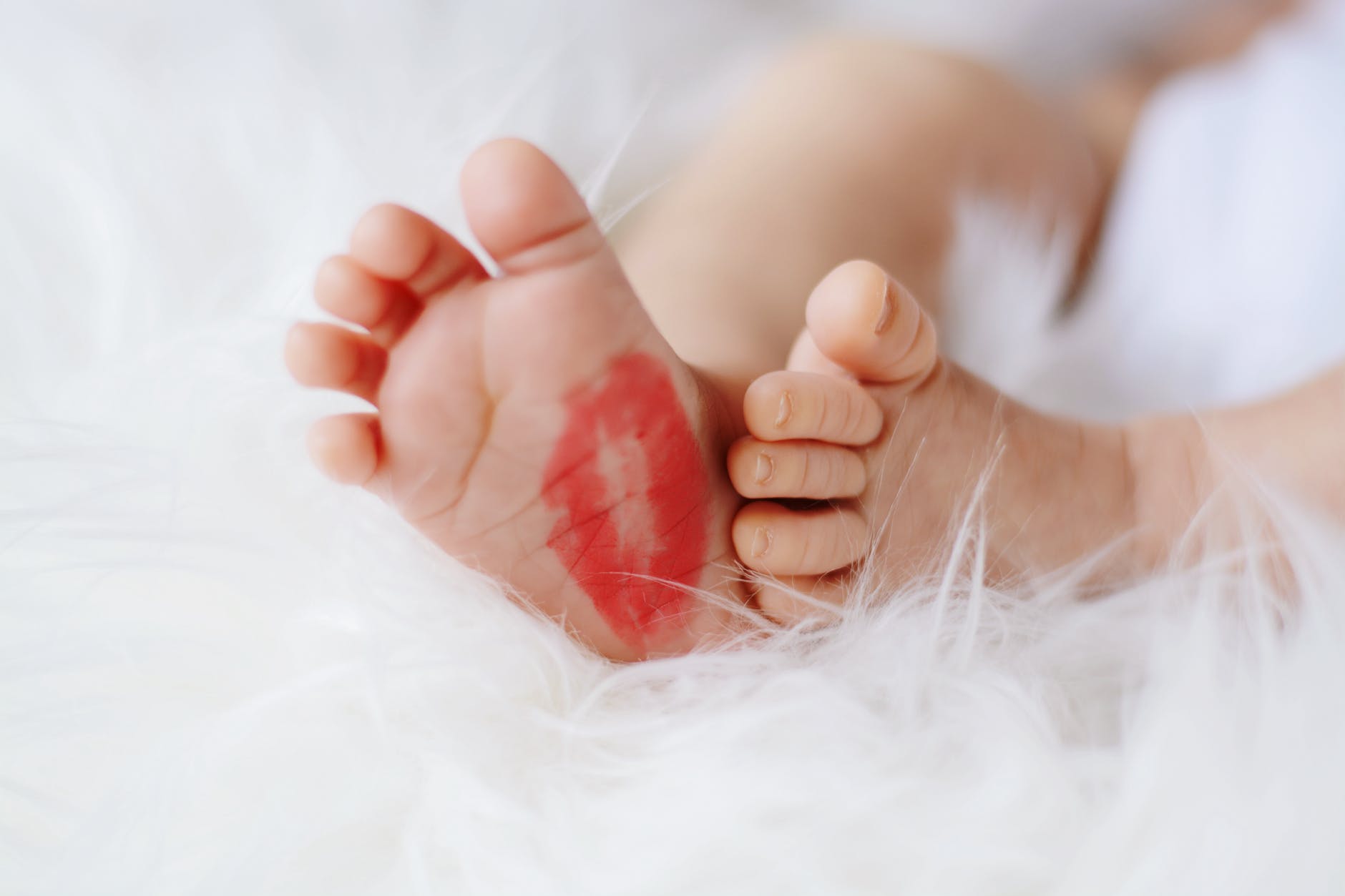 baby foot with red kiss mark